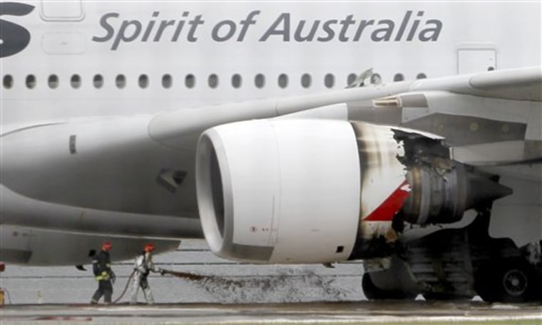 Firefighters surround a Qantas passenger plane that made an emergency landing with 459 people aboard in Singapore after having engine problems on Nov. 4.